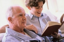 boy reading to recovering patient