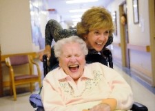 patient laughing during wheelchair ride