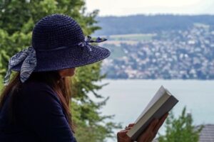 Woman reading by a lake