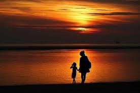 two people walking by the water