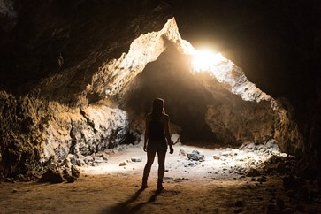 woman entering a cave